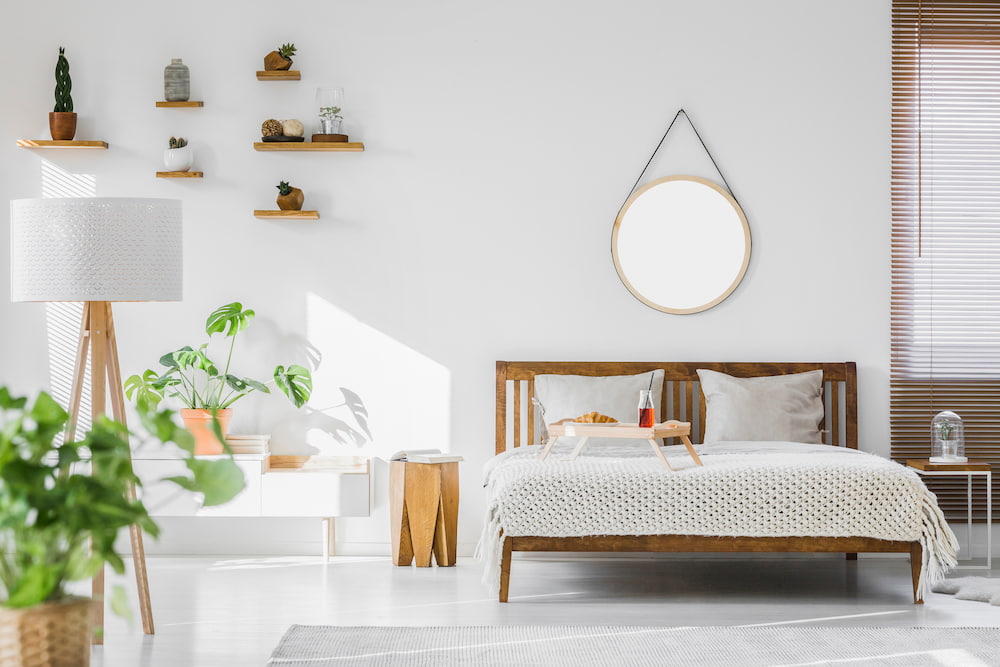 organized and decluttered bedroom with floating shelves and plants