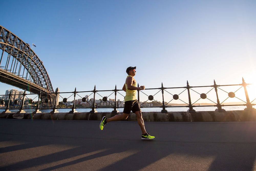 a runner runs along a running path which runs next to a running river