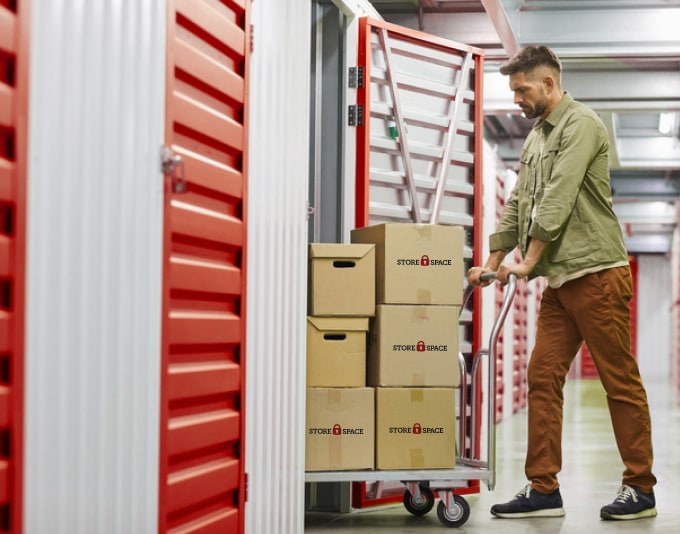 Man putting boxes in storage unit