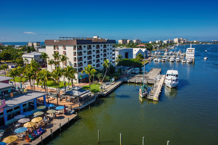 Fort Meyers Beach Fort Meyers pier with boat and buildings.