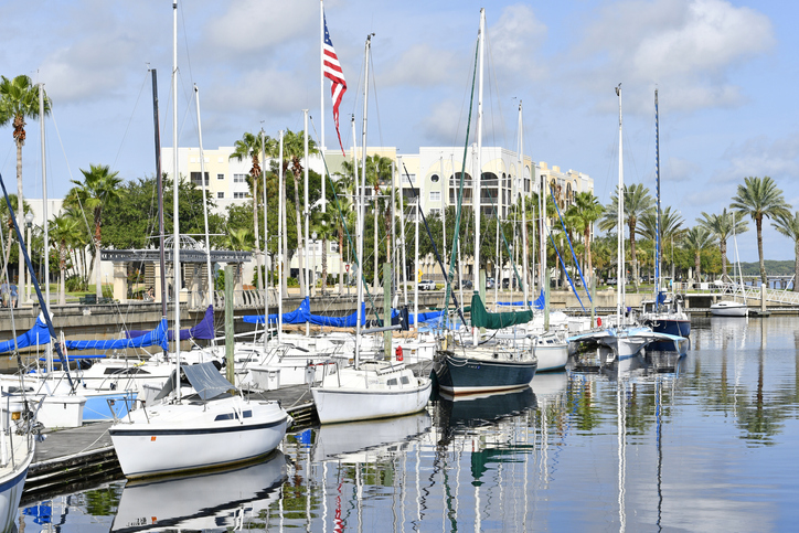 A lot of sailing boats on a pier.