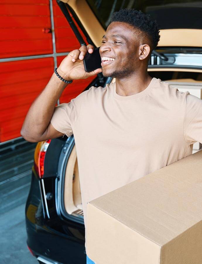 A smiling man on a phone call.