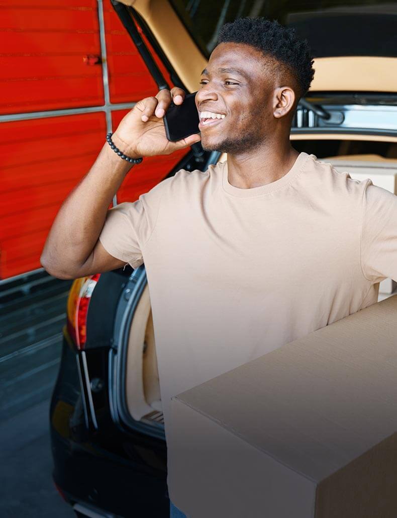 A smiling man on a phone call.