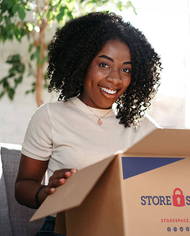 A woman holding a Store Space box.